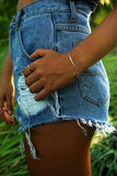 hammered silver bar bracelet and cut off high waisted jean shorts for simple every day style